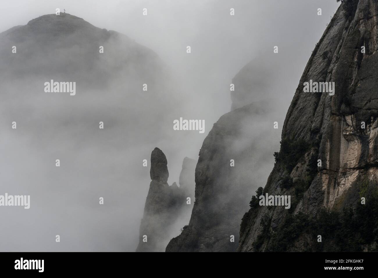 Rising clouds and mist obscure the peaks of Catalonia’s most famous natural landmark in the early morning after some heavy rainfall, resulting in moisture engulfing the peaks of the Montserrat mountain range, west of Barcelona in the province of Catalonia, Spain. © Olli Geibel Stock Photo