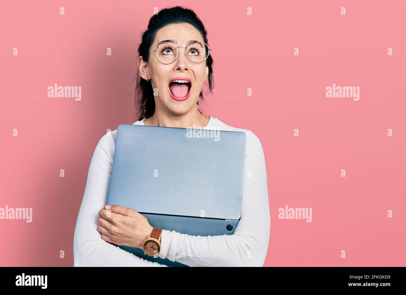 Young hispanic woman working using computer laptop angry and mad ...