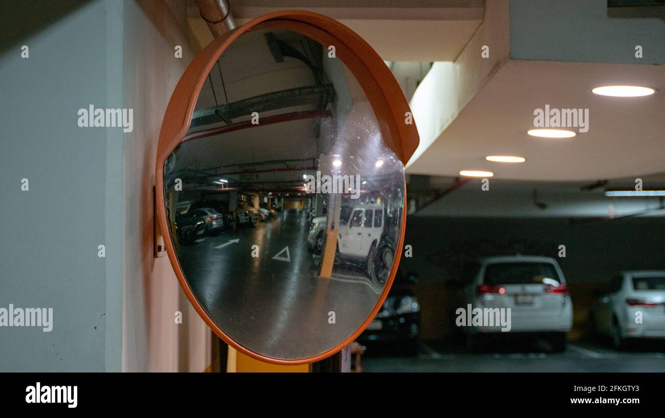 Curve mirror at a basement parking Stock Photo - Alamy