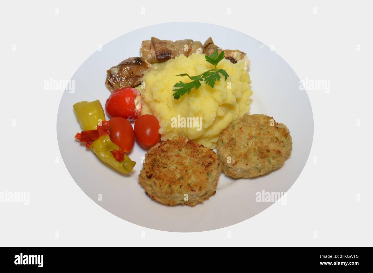 chicken cutlets with mashed potatoes, tomatoes, pepperoni Stock Photo