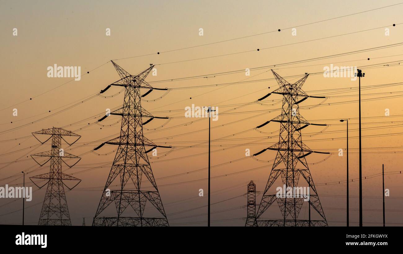 high voltage electric towers during sunset. Selective focus Stock Photo ...