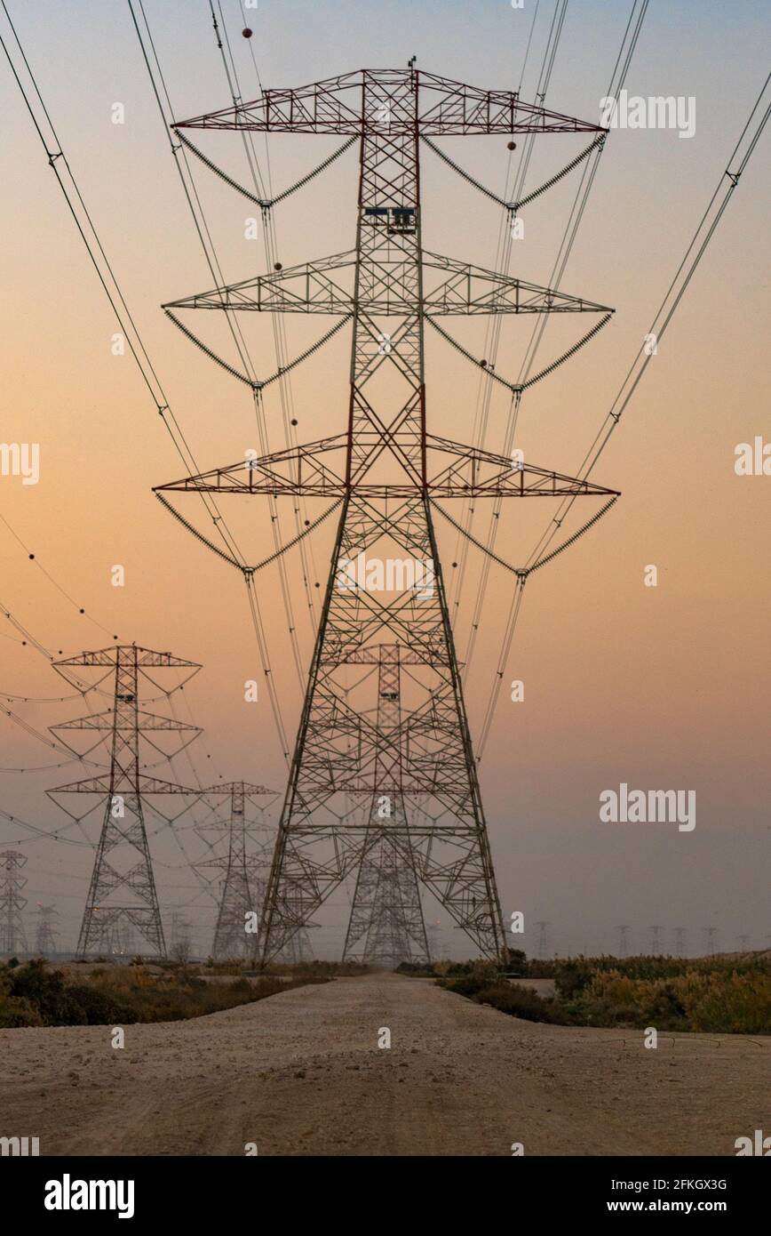 high voltage electric towers during sunset. Selective focus Stock Photo ...