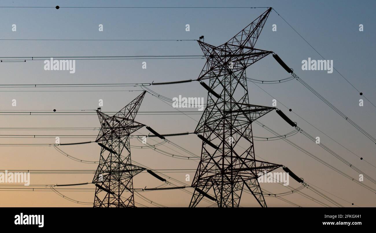 high voltage electric towers during sunset. Selective focus Stock Photo ...