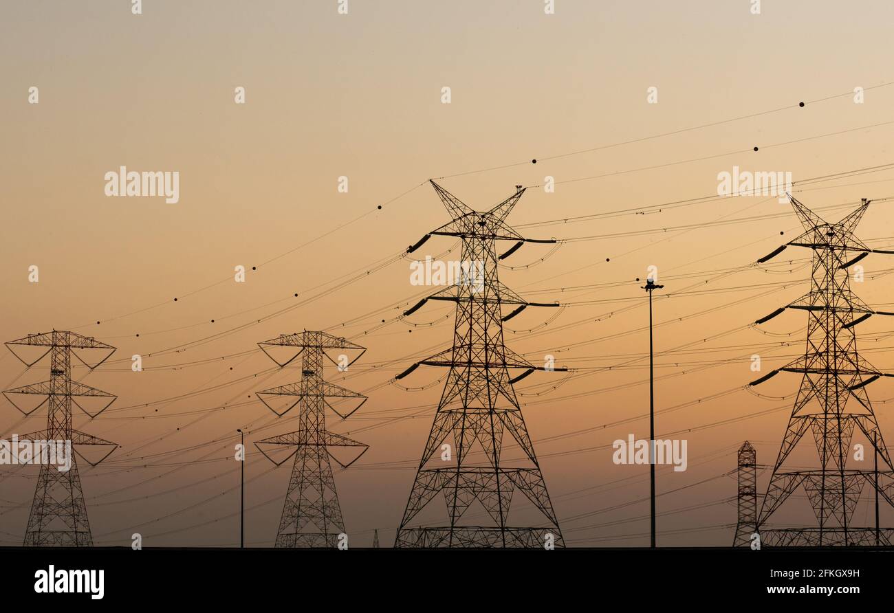 high voltage electric towers during sunset. Selective focus Stock Photo ...