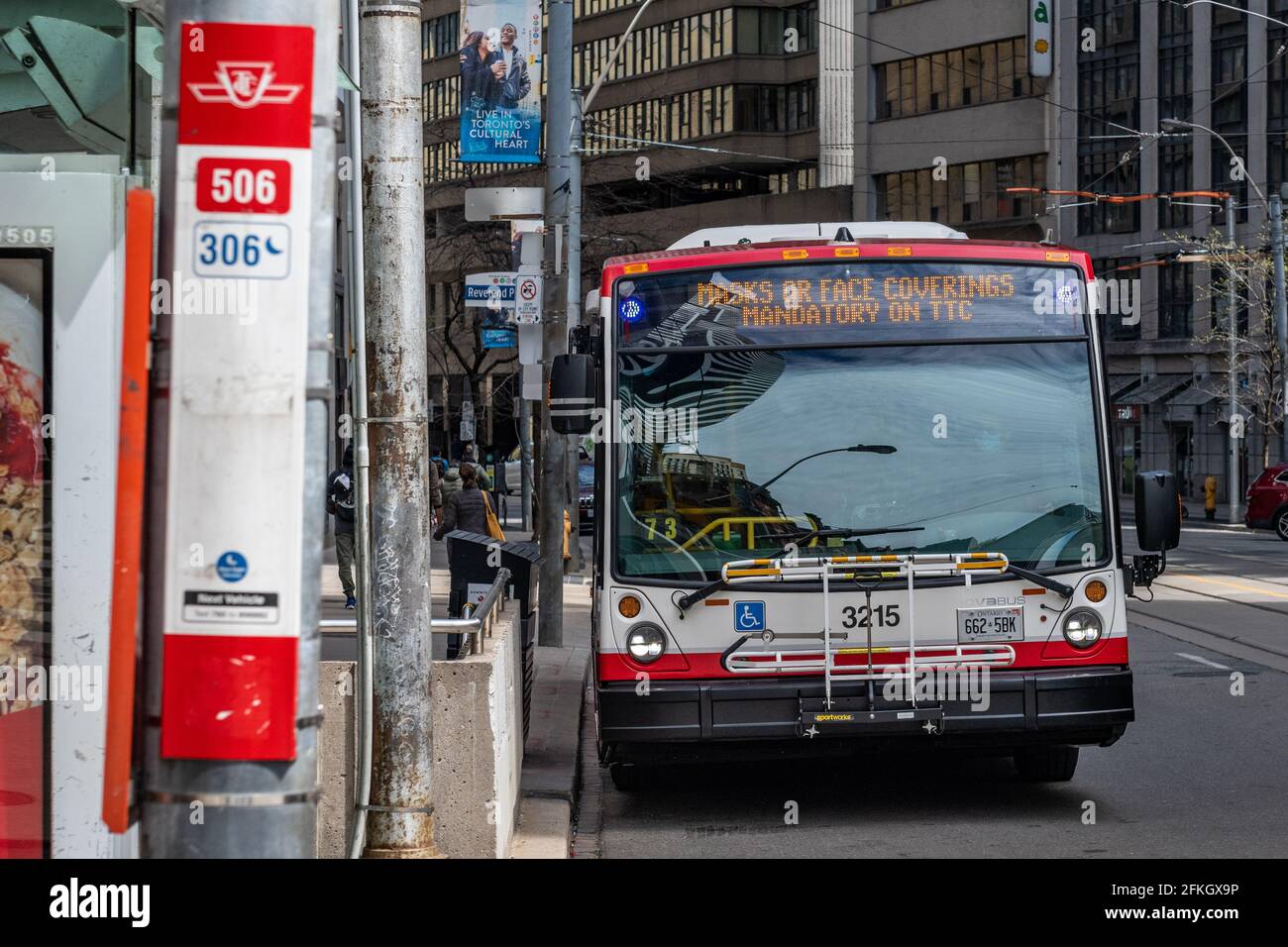 TTC (Toronto Transit Commission) bus with a sign explaining that protective face masks are mandatory in the public transportation system during the Co Stock Photo