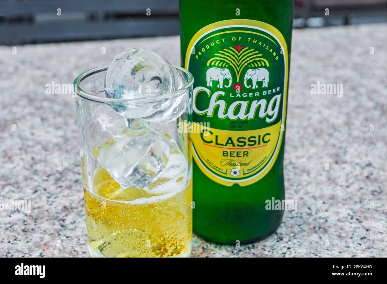Thai Chang beer bottle and glass with ice cubes night market Bangkok