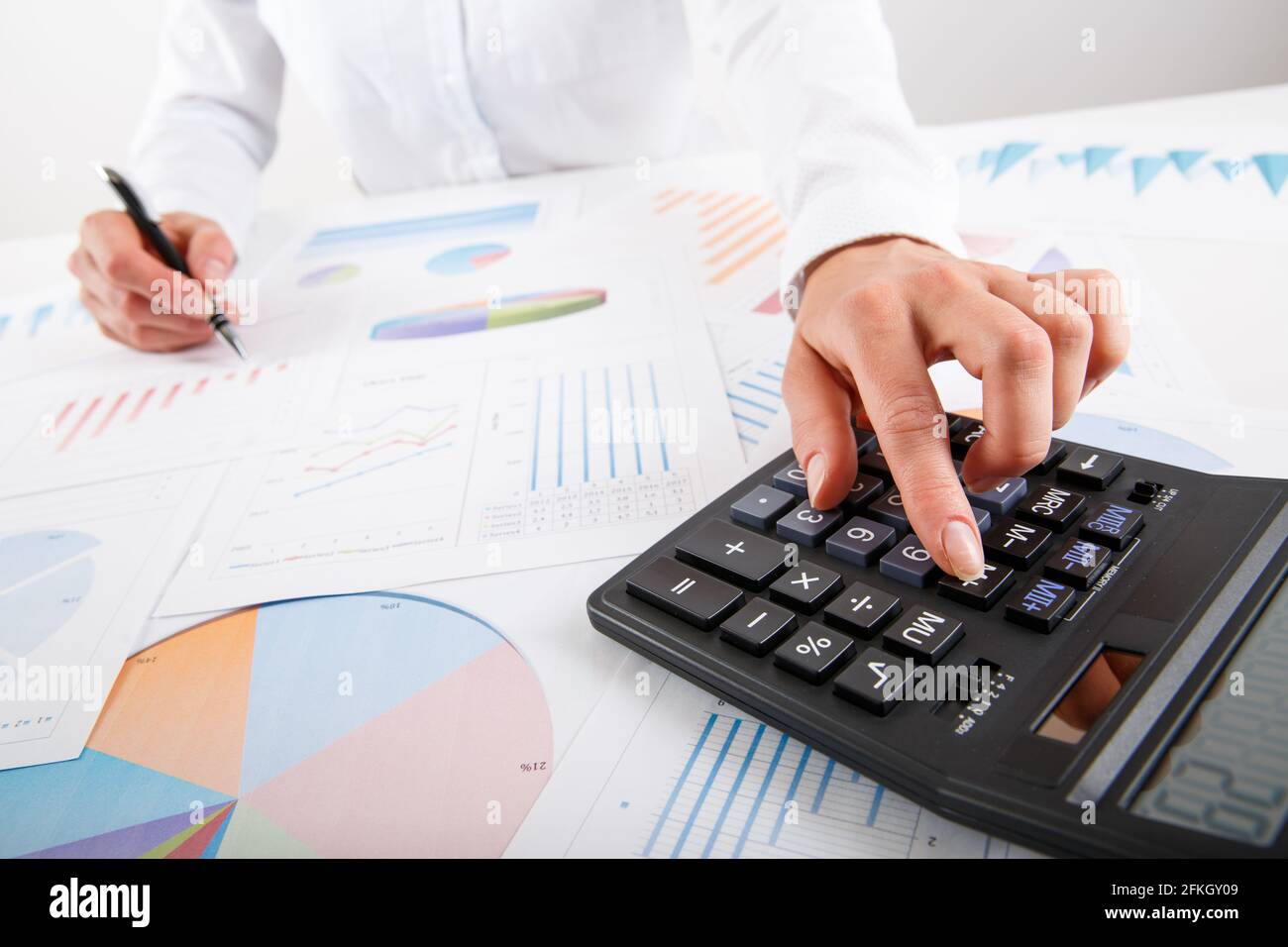 Business woman pointing at graph document close-up. Young business ...