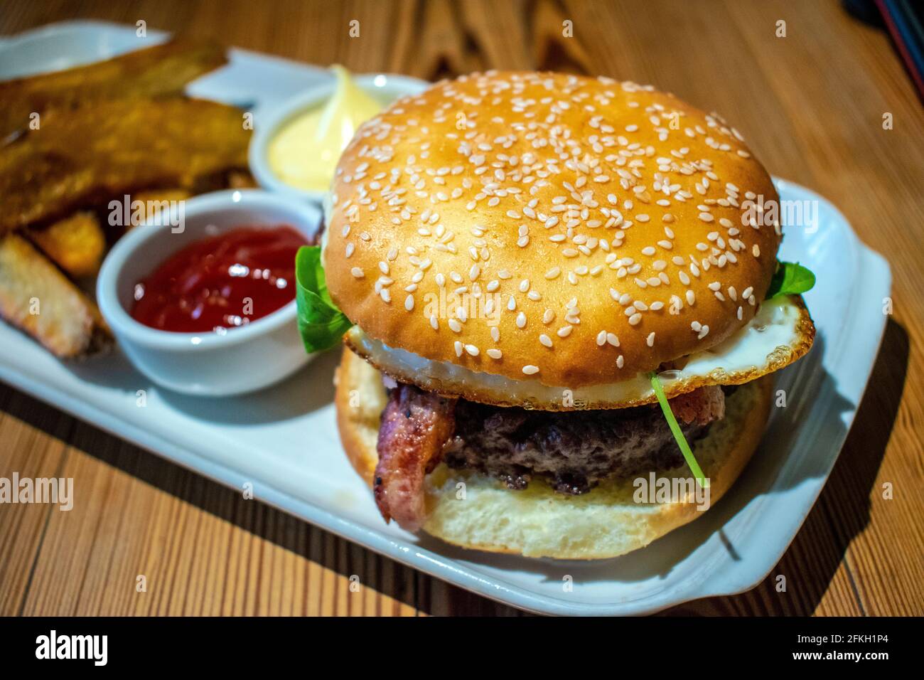 Homemade burger with rustic fries, mayonnaise and ketchup Stock Photo
