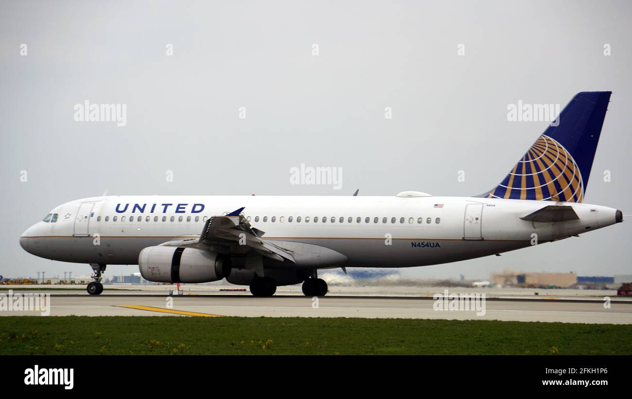 United Airlines Airbus A320 taxies on the runway after landing at Chicago O'Hare International Airport. The plane's registration is N454UA Stock Photo