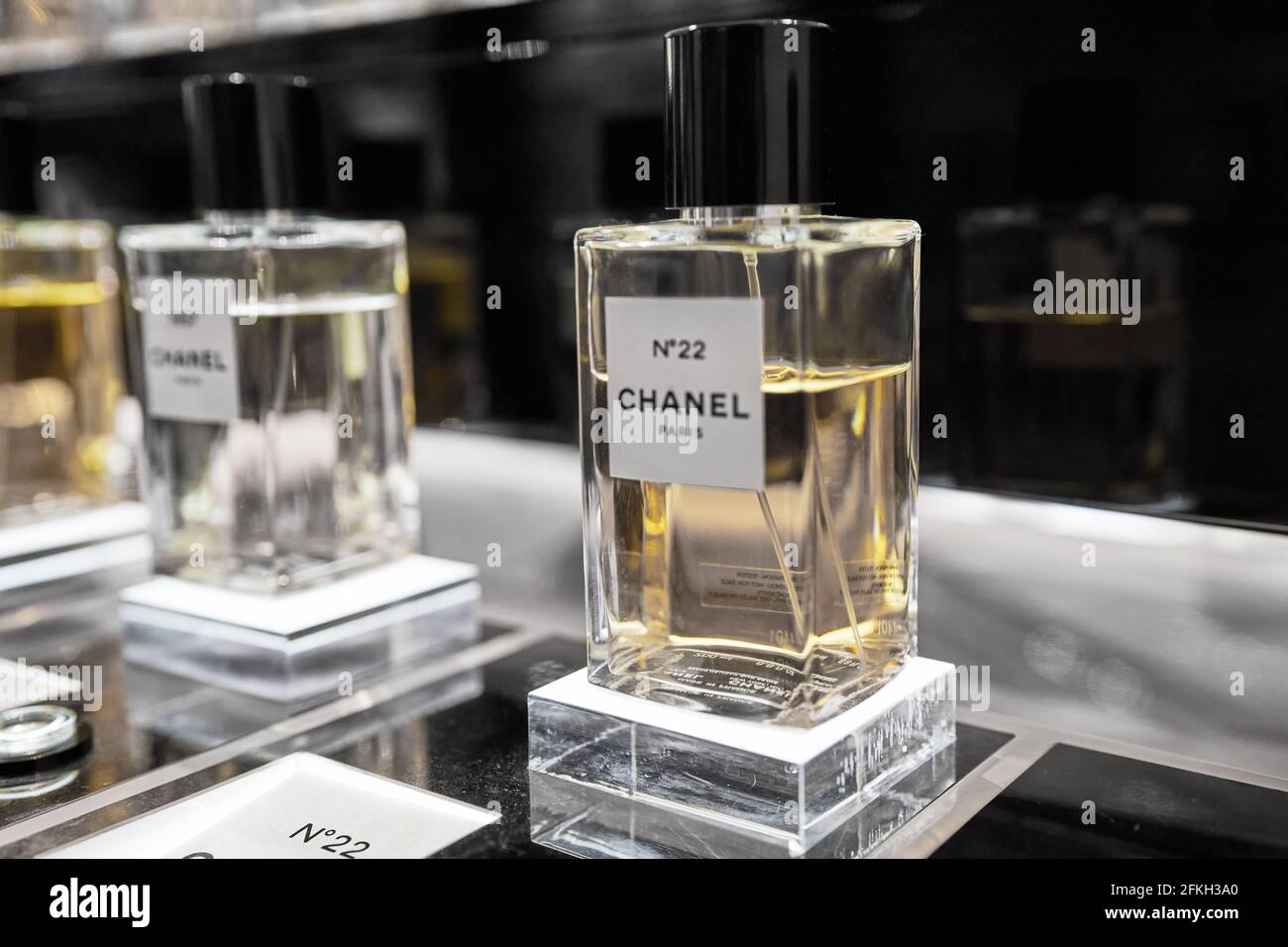 Female perfume Chanel No. 22 bottle closeup in store showcase. Perspective view of french Chanel perfume collection. Milan, Italy - December 15, 2020. Stock Photo