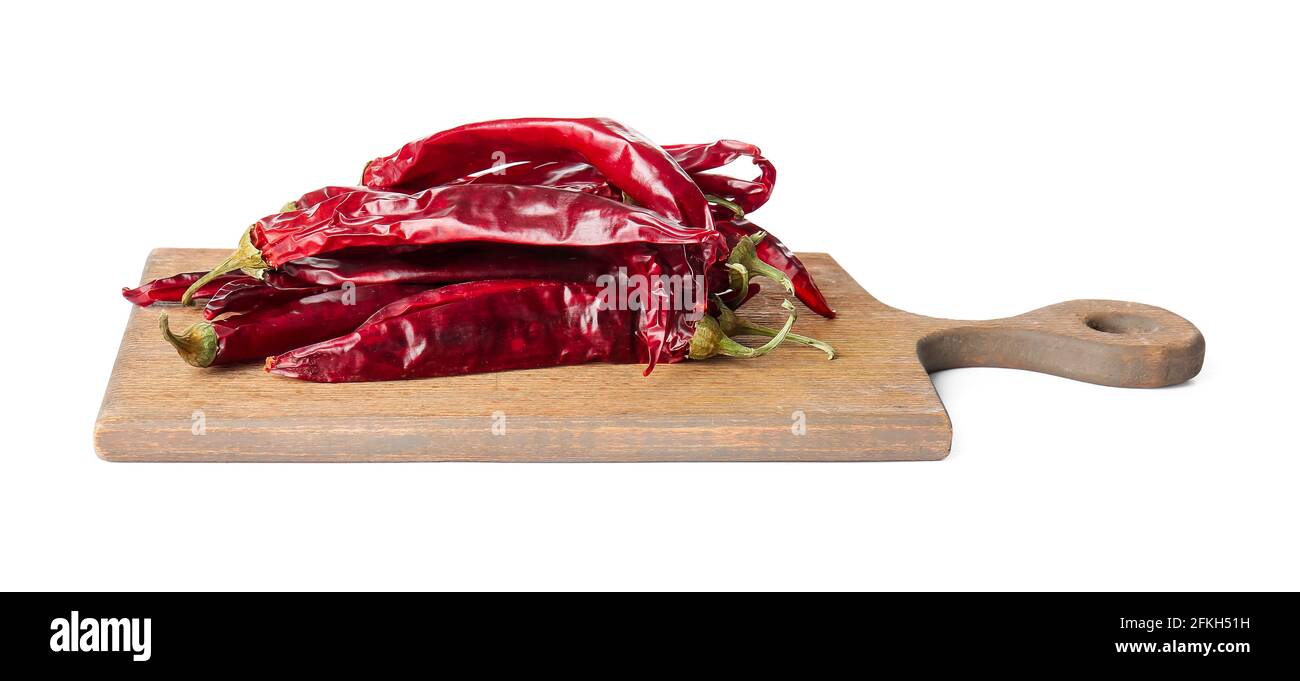 Wooden board with dry chili peppers on white background Stock Photo - Alamy