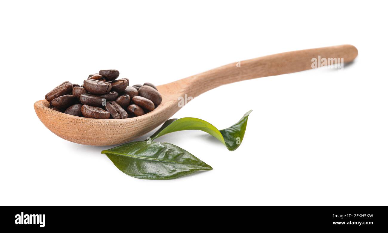 Spoon with coffee beans on white background Stock Photo - Alamy