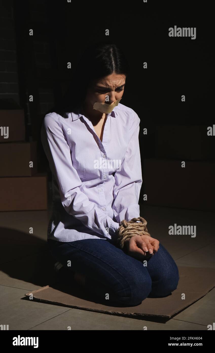 Female hostage in dark room Stock Photo - Alamy