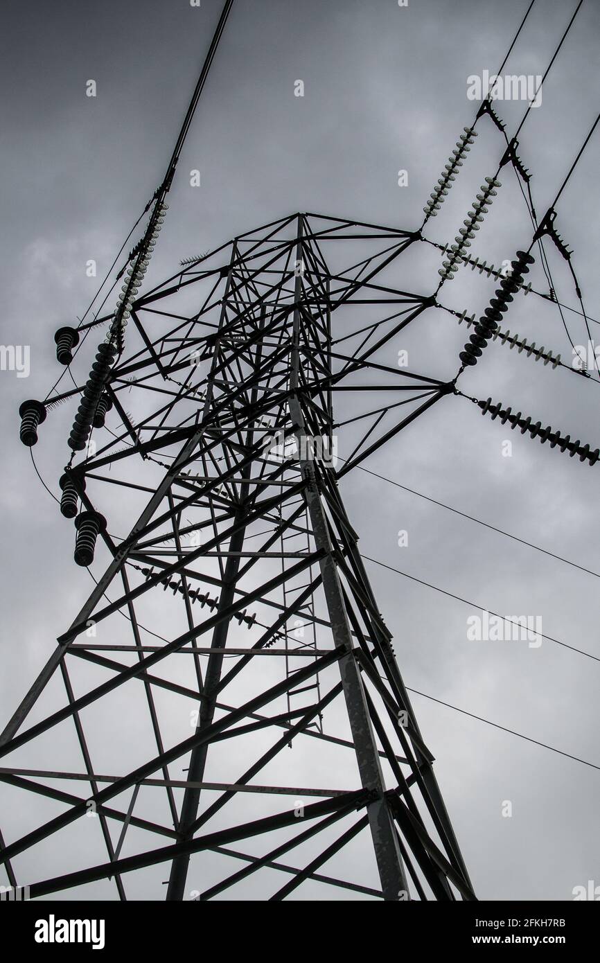 Looking up at a transmission tower / power tower on a grey, cloudy day ...