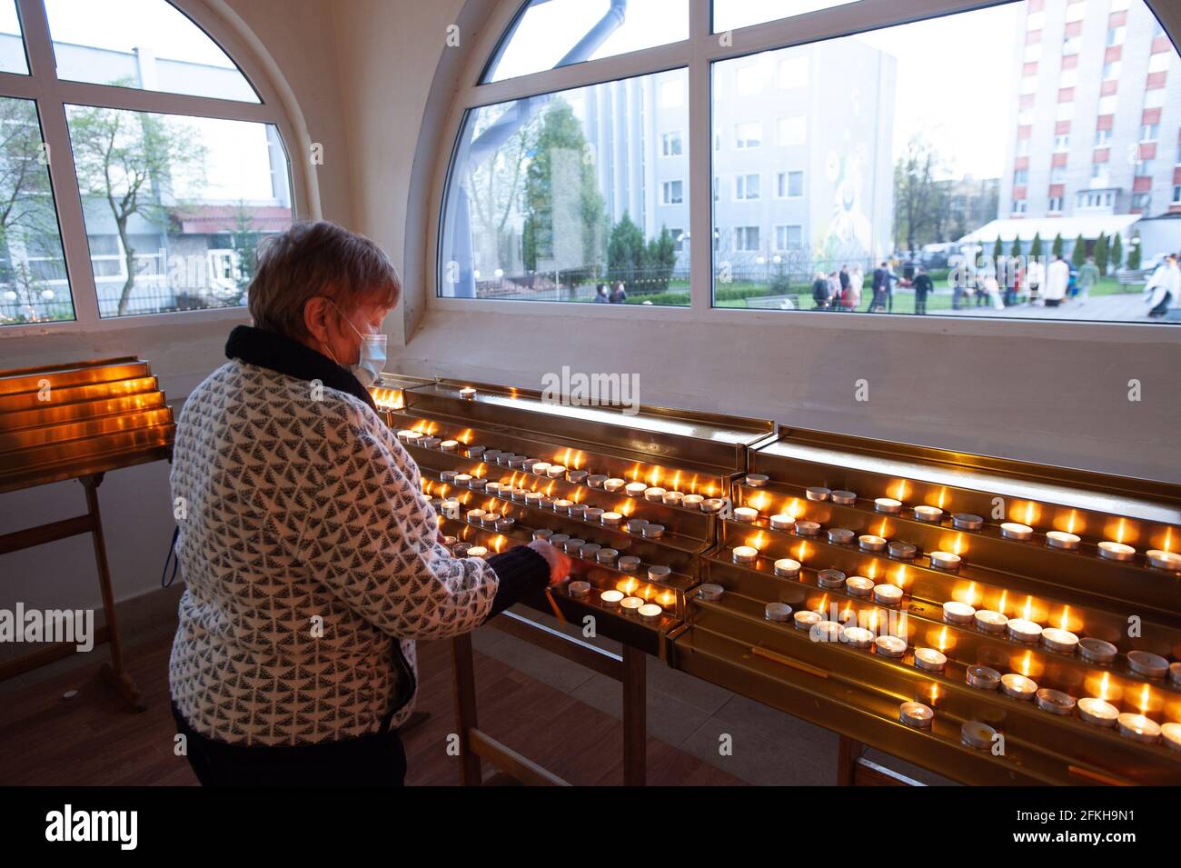 Lviv, Ukraine. 01st May, 2021. An old woman lights up candles at a Church as they celebrate Easter to mark the resurrection of Jesus Christ from the dead and the foundation of the Christian faith. (Photo by Mykola Tys/SOPA Images/Sipa USA) Credit: Sipa USA/Alamy Live News Stock Photo
