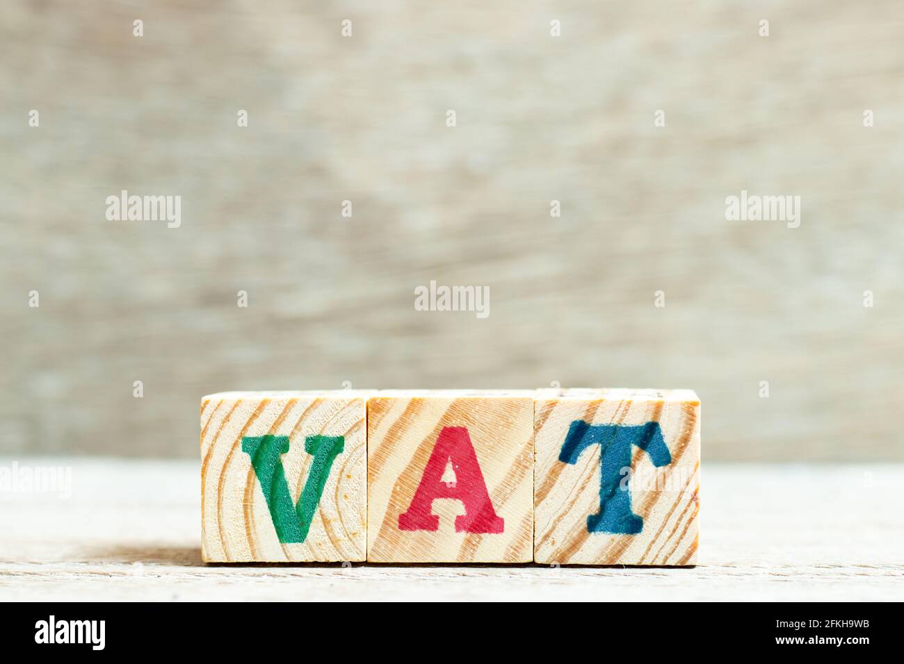 Alphabet letter block in word vat (abbreviation of value added tax) on wood background Stock Photo