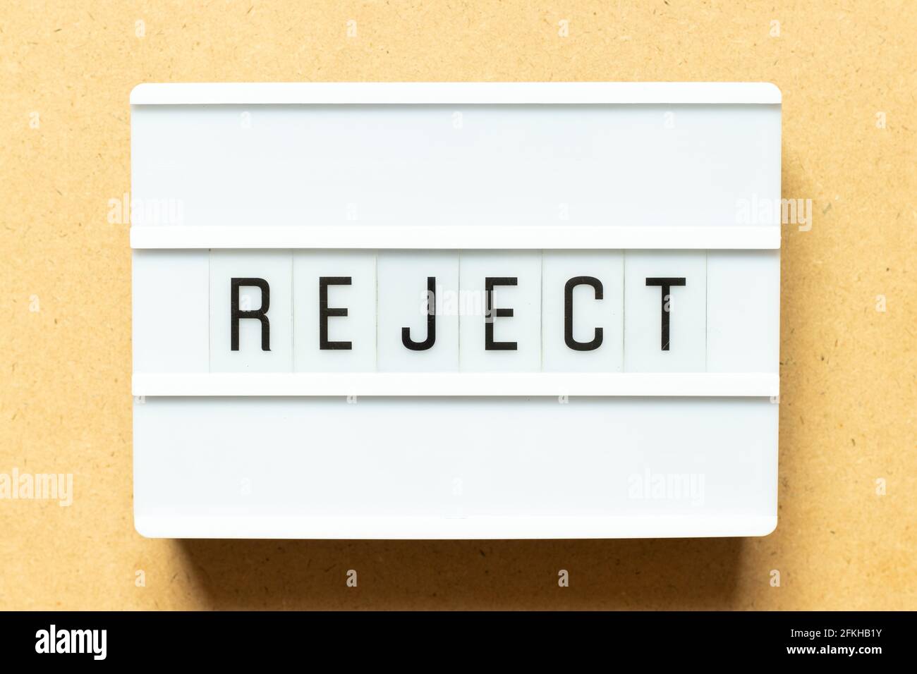 Lightbox with word reject on wood background Stock Photo
