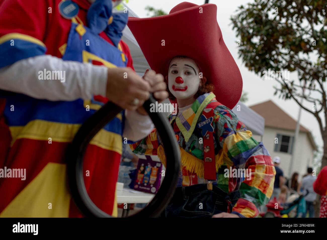 Roanoke, Texas, USA. 1st May, 2021. 5/1/21 Roanoke, Texas - A clown helps fellow clones blow balloons from kids during the 5th Annual Roanoke Roundup. This is one of the first public fairs that have taken place since Texas has opened up 100% since the COVID-19 pandemic hit the state. Credit: Chris Rusanowsky/ZUMA Wire/Alamy Live News Stock Photo