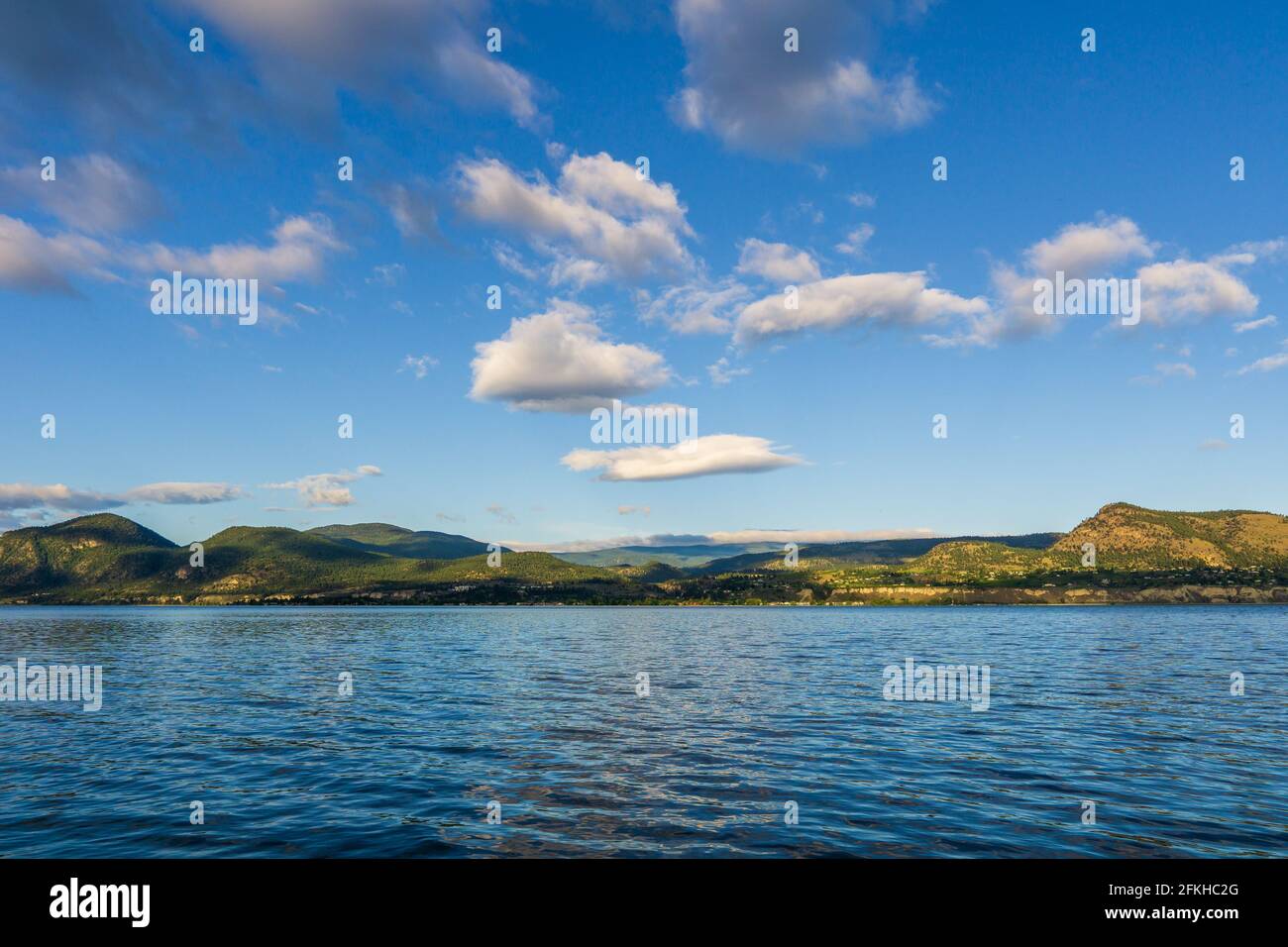 Beautiful calm summer morning on the lake with clouds on the sky Stock Photo