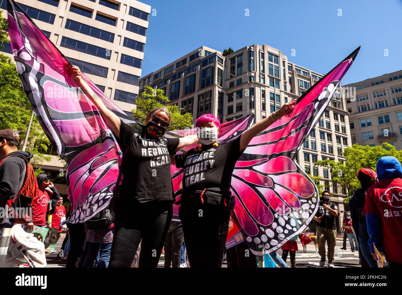Washington, DC, United States, 1 May, 2021.  Pictured: Lariza Dugan Ciara (left) and Ani Rivera wear pink butterfly wings while marching with Caravana para Los Niños (Caravan for the Children) during a large march for immigrant rights and citizenship.  Credit: Allison C Bailey / Alamy Live News Stock Photo