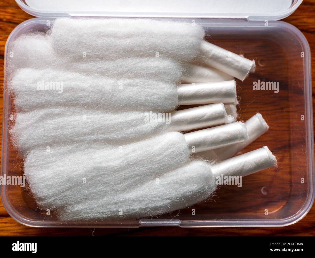 Several stripes of cotton for vaping with a sheath at one end Stock Photo