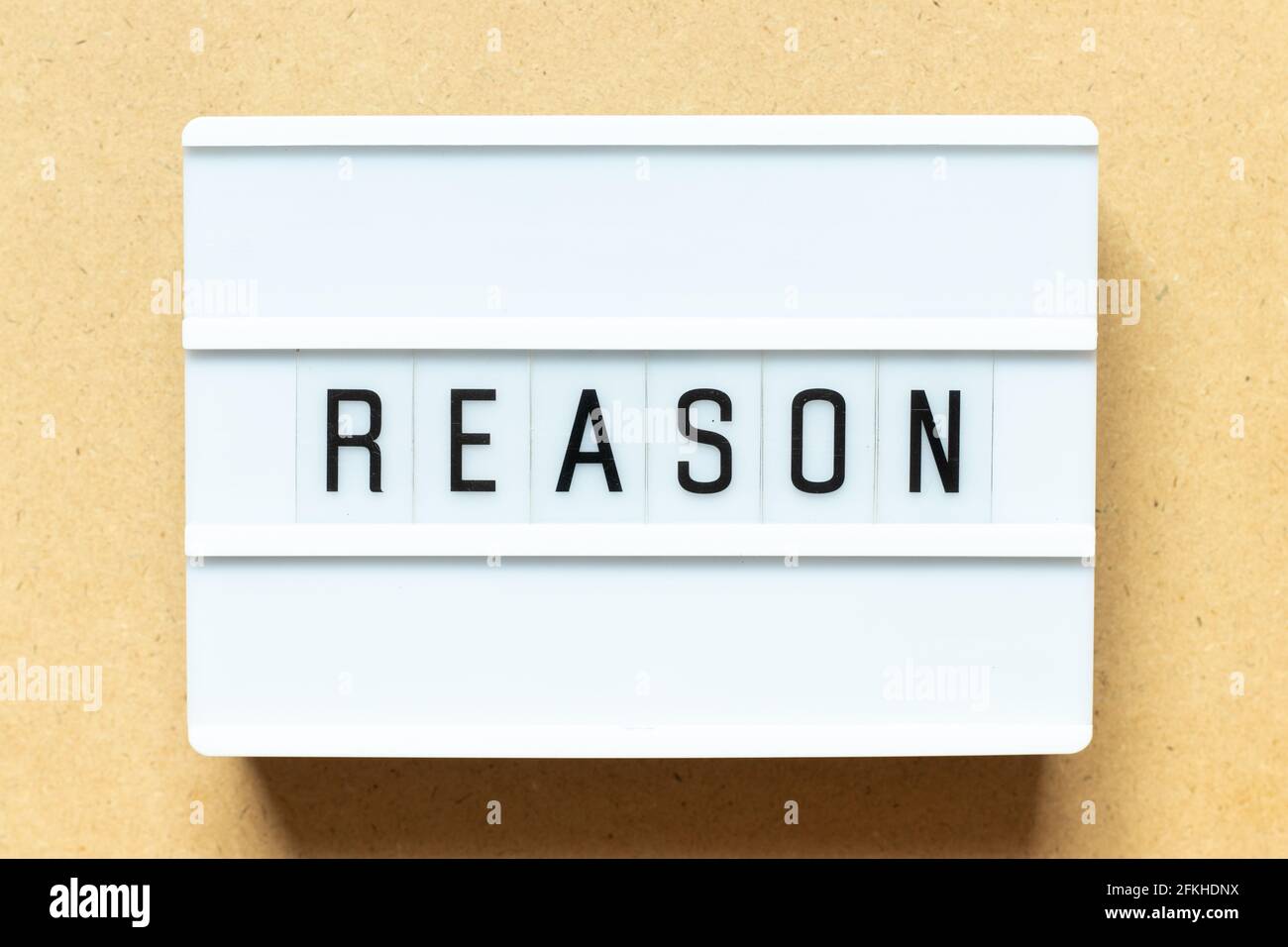 Lightbox with word reason on wood background Stock Photo