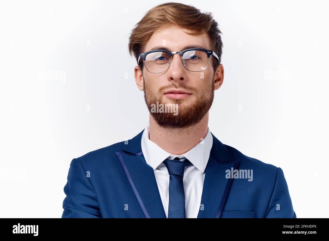 business man in a suit and glasses holds his hand near his face on a ...