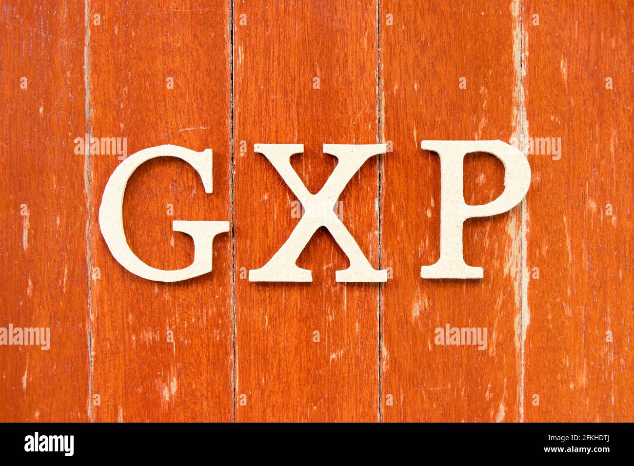 Alphabet letter in word GXP on old red color wood plate background Stock Photo