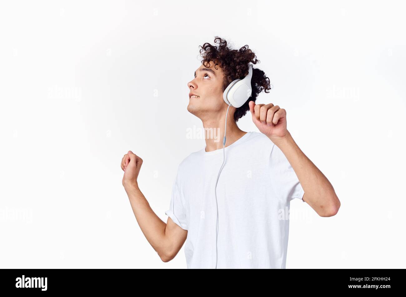 cheerful-guy-in-headphones-listens-to-music-gesturing-with-his-hands