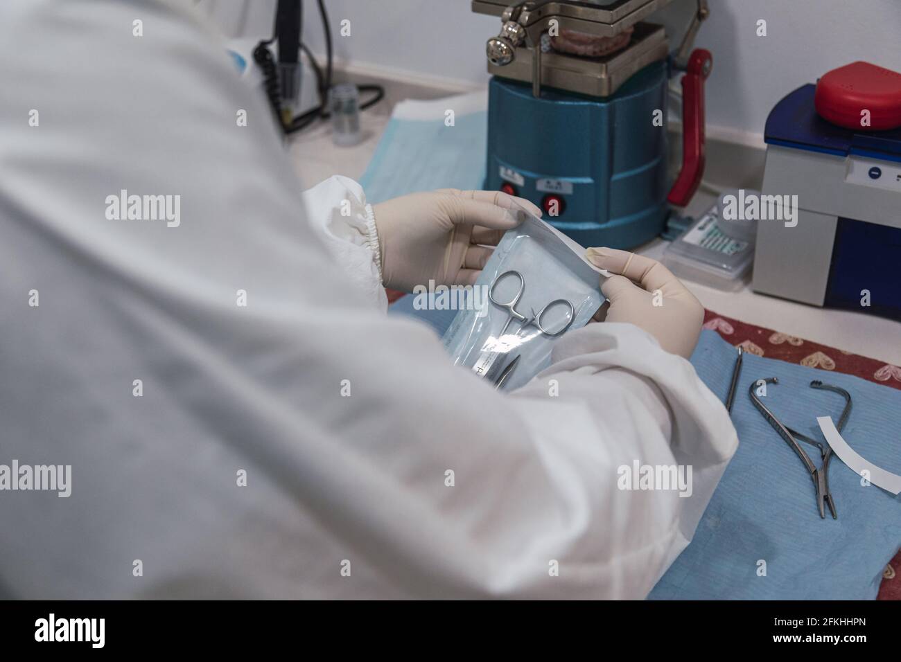 Nurse packs a dental instrument before its sterilization in a dental
