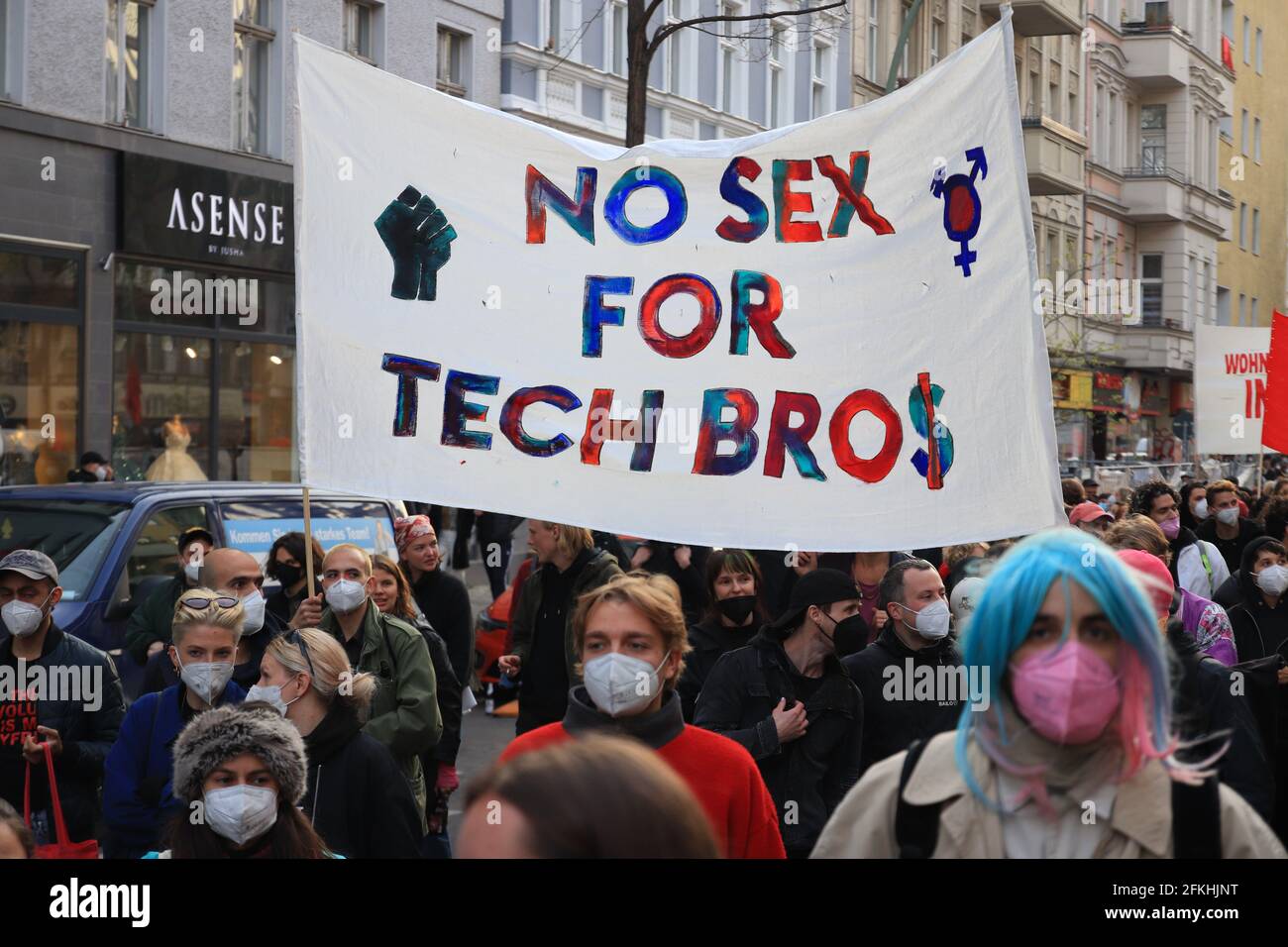Berlin, Germany - May 01, 2021: Protesters holding a banner with the slogan ' No sex for tech bros' at 1st May Demonstrations on the streets of Berlin Stock Photo