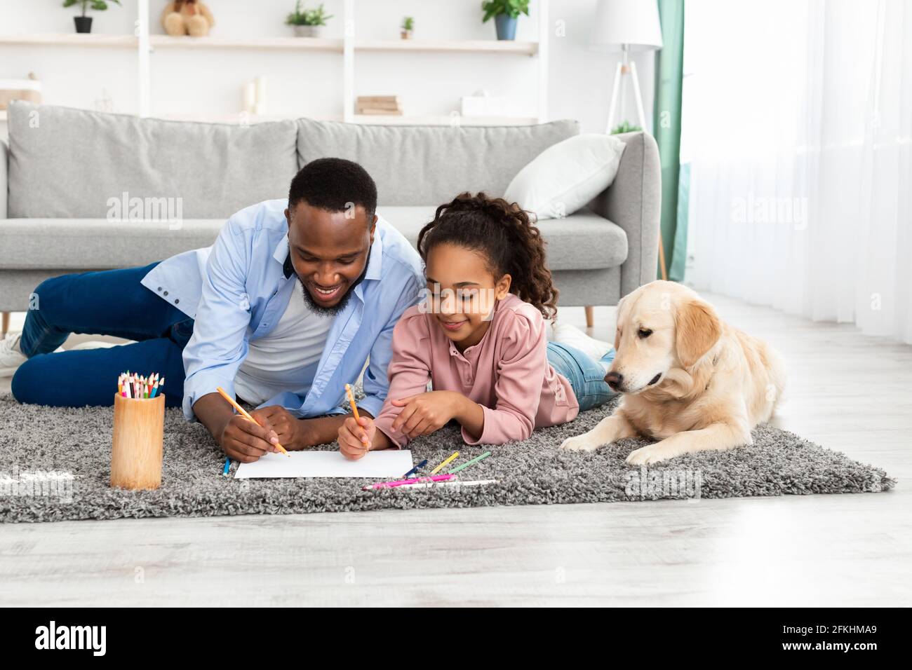 Portrait of a happy black family spending time at home Stock Photo - Alamy