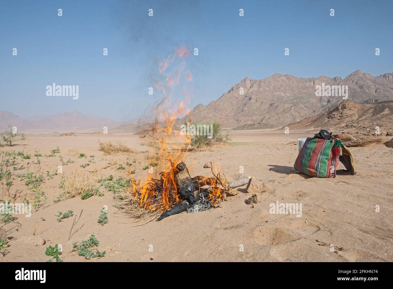 Landscape scenic view of desolate barren eastern desert in Egypt with campfire burning for cooking Stock Photo