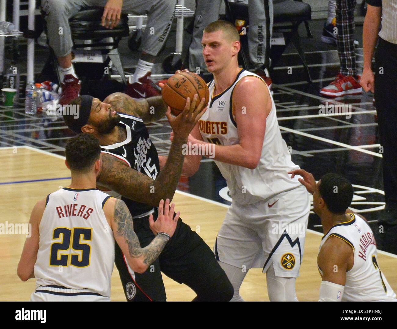 Los Angeles, United States. 02nd May, 2021. Los Angeles Clippers' center DeMarcus Cousins (15) is triple-teamed as he scores on Denver Nuggets' center Nikola Jokic (15) during the second half at Staples Center in Los Angeles on Saturday, May 1, 2021. The Nuggets defeated the Clippers 110-104. Photo by Jim Ruymen/UPI Credit: UPI/Alamy Live News Stock Photo