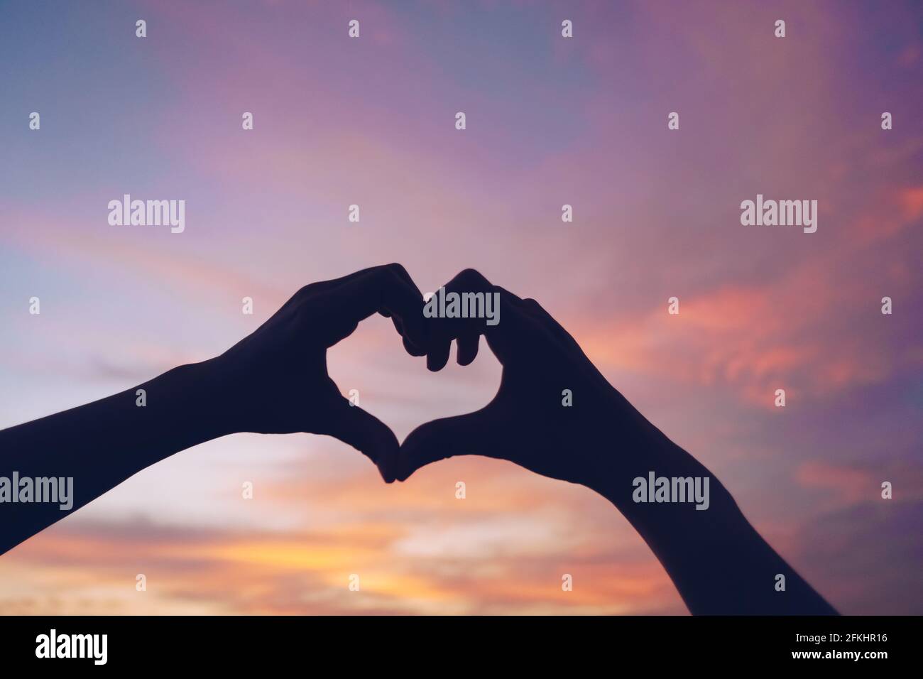 Woman hand do heart shape on nature blue sky background Stock Photo - Alamy