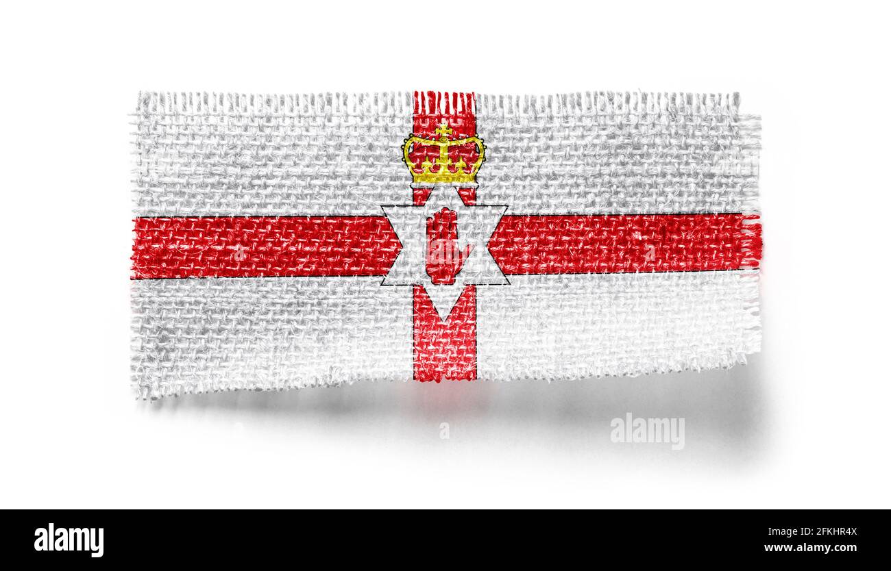 Northern Ireland flag on a piece of cloth on a white background Stock ...