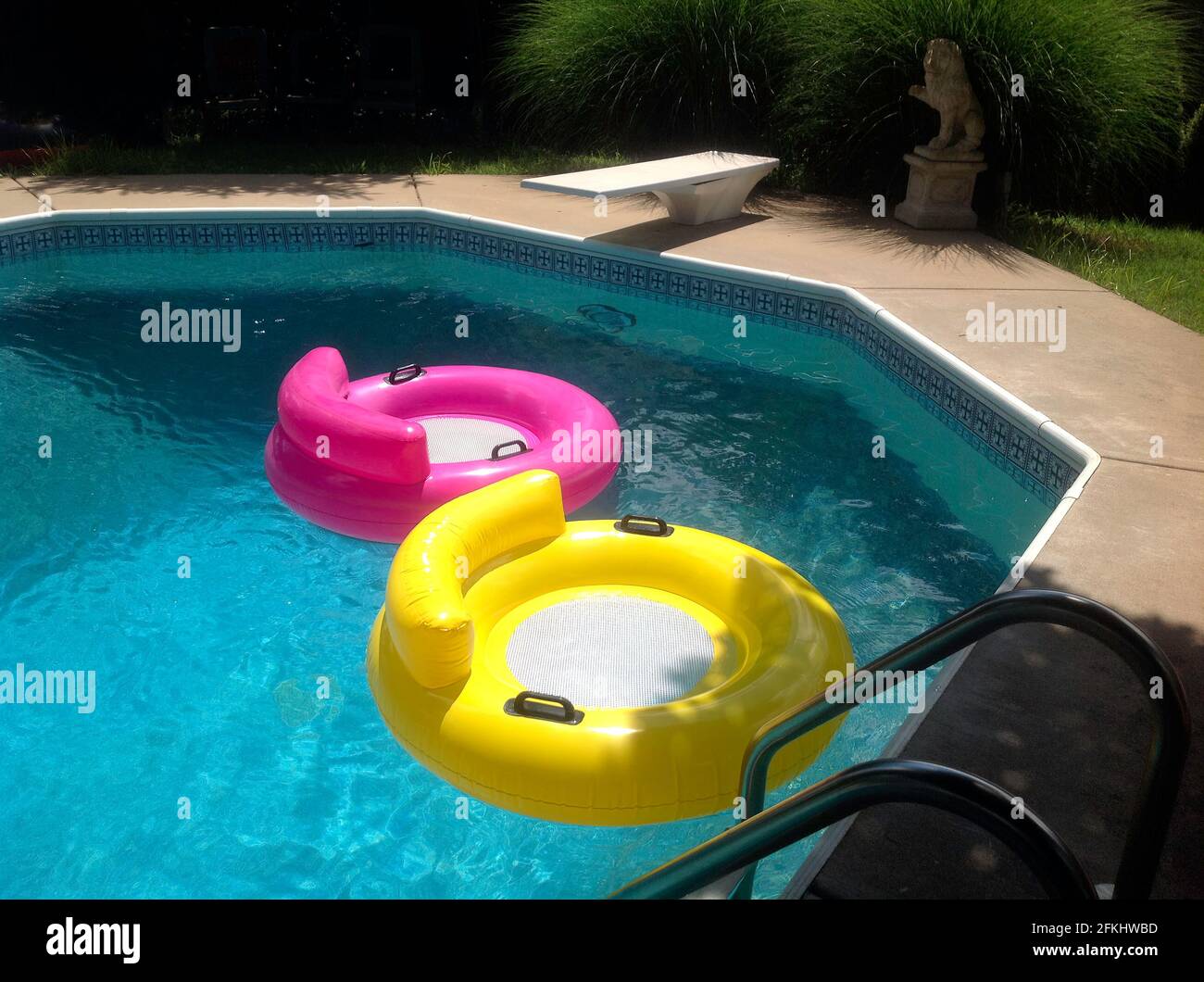 Hot pink and mellow yellow pool rings beg for a dip on a hot summer afternoon. Stock Photo
