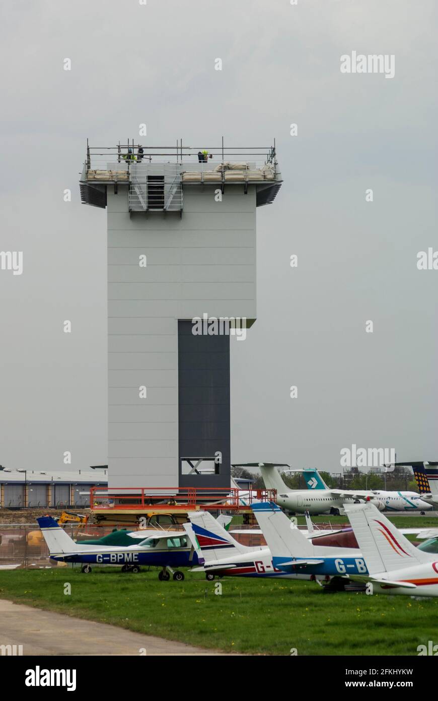 Air Traffic Control tower under construction at the developing London Southend Airport, Essex, UK, with flying club planes which would be forced out Stock Photo