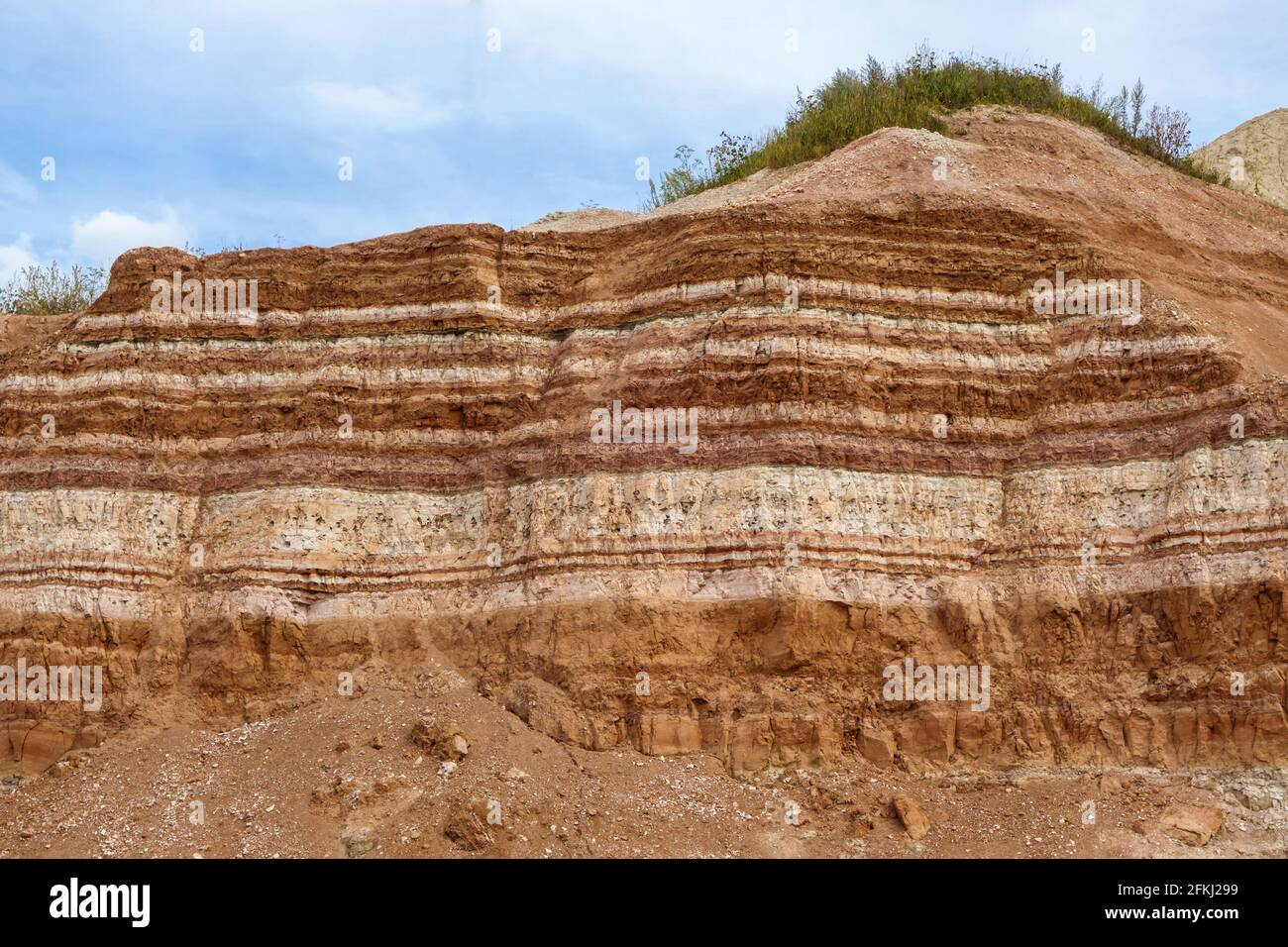 Surface of working wall in open pit mine. It's showing underground resource layers, useful & empty Stock Photo
