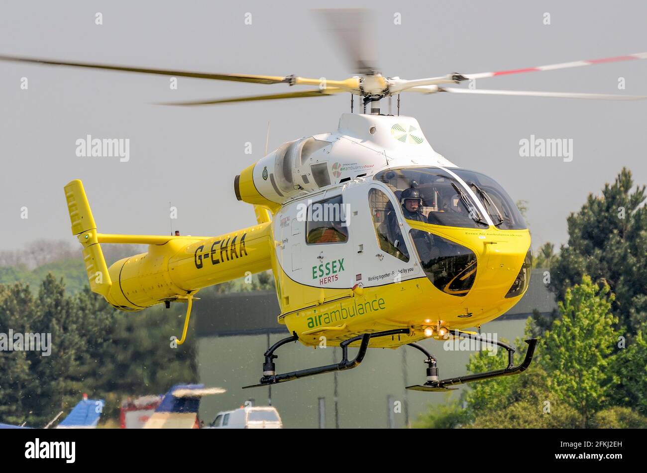Essex & Herts Air Ambulance helicopter G-EHAA at Earls Colne airfield, Essex, UK. MD Helicopters MD Explorer aircraft. HEMS. Landing Stock Photo