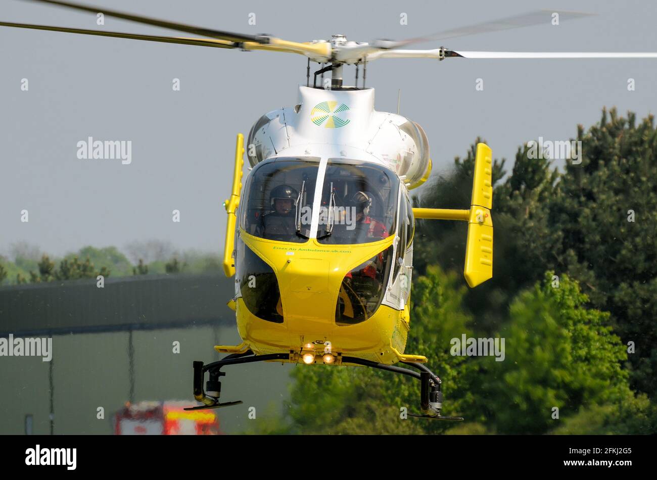 Essex & Herts Air Ambulance helicopter G-EHAA at Earls Colne airfield, Essex, UK. MD Helicopters MD Explorer aircraft. HEMS. Landing Stock Photo