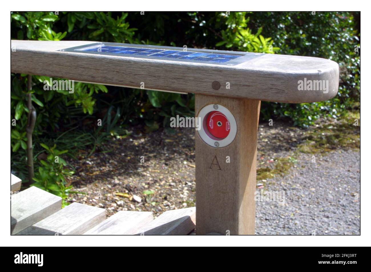 A memorial bench to Ian Dury in poets corner, Pembrook Lodge, Richmond park.The public can listen to the music and interviews of Dury by pluging her headphones into sockets in the arm rests of this special bench with solar panels to power the bench.pic David Sandison 29/4/2002 Stock Photo