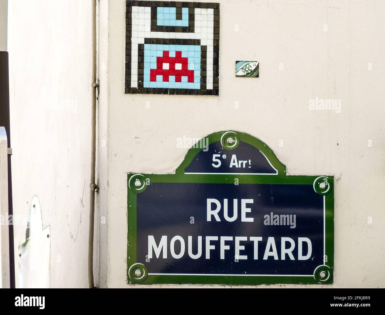 Street art work of space invader in Paris, France on historical building in city center, rue Mouffetard in 5 arrondissement. Stock Photo