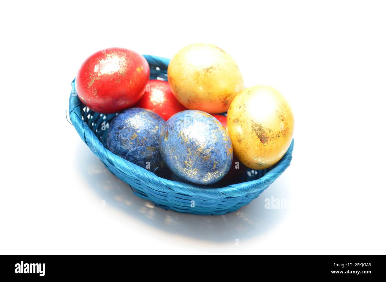 blue basket with easter eggs, basket with Easter eggs on a white background, painted eggs with gold Stock Photo
