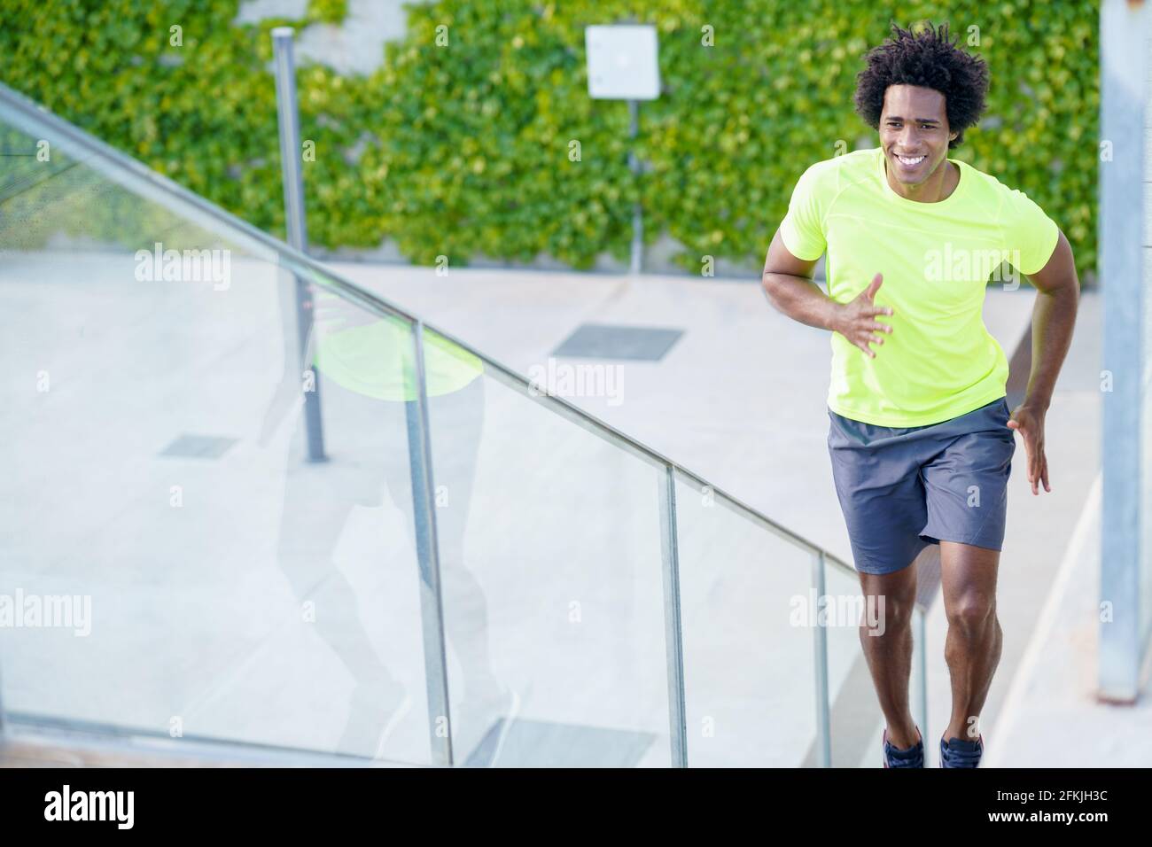 Black man running up stairs hi-res stock photography and images - Alamy