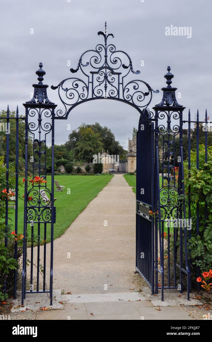 View of decorative garden gate from Trinity College Garden Quad, Oxford, United Kingdom. Overcast Sky. Stock Photo