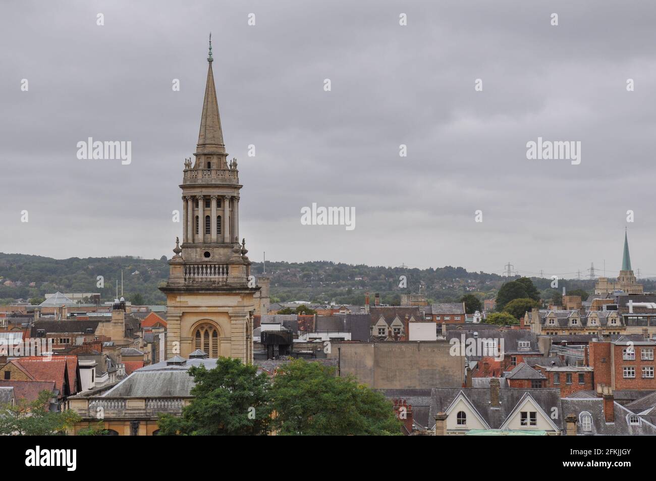 Rooftop view on historical university buildings towards All Saints Church, Oxford, United Kingdom. Overcast sky. Stock Photo