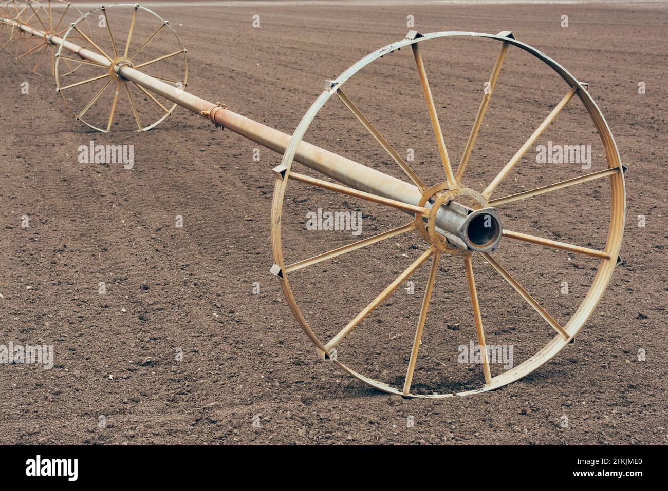 Wheel line irrigation equipment in ploughed field, agriculture and farming Stock Photo Alamy