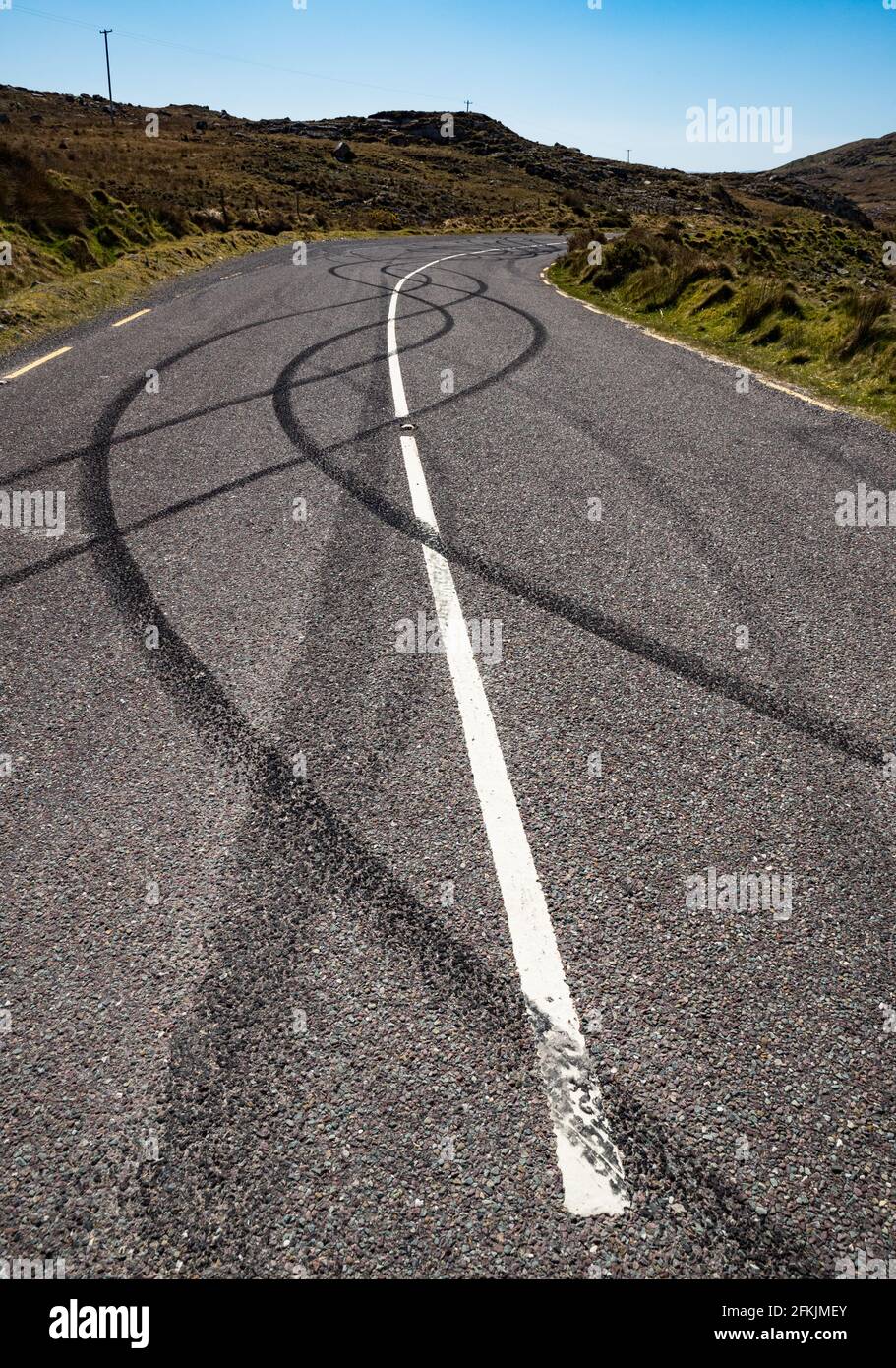 Black tire burnout track on rural road due to illigal car drifting Stock Photo