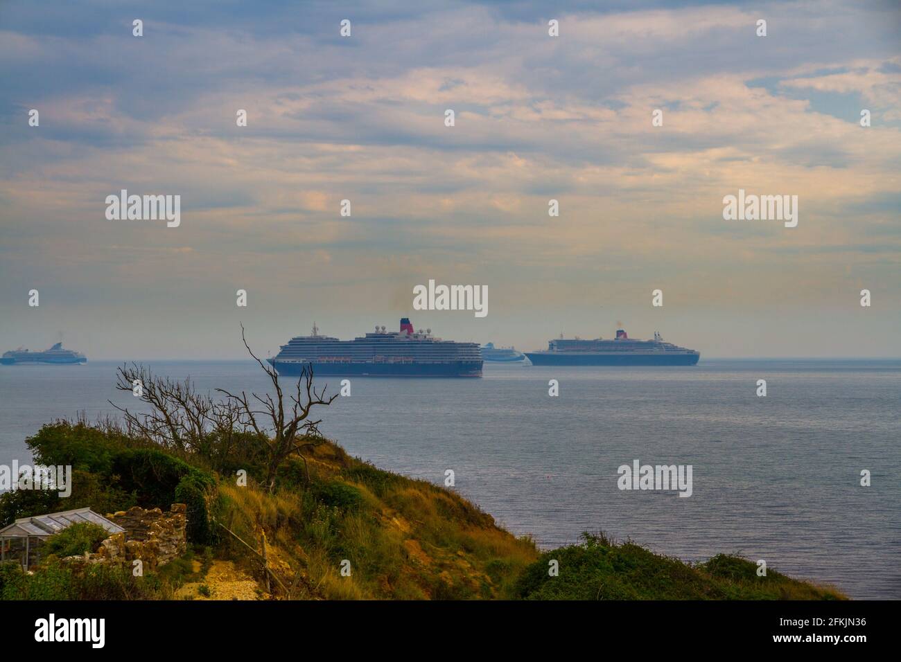 WEYMOUTH - AUGUST 16 2020: Four Cruise Ships, moored off Dorset, England due to Covid 19 Pandemic, landscape Stock Photo
